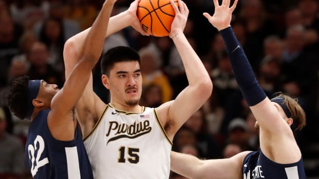 Penn State Nittany Lions guard Jalen Pickett (22) and Penn State Nittany Lions forward Michael Henn (24) defend Purdue Boilermakers center Zach Edey (15) during the Big Ten Men s Basketball Tournament Championship game, Sunday, March 12, 2023, at United Center in Chicago. Purdue won 67-65.